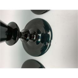 19th century green glass ships decanter with flat topped stopper, H21.5cm, together with a set of four 19th century green glass wine glasses, the funnel bowls upon bladed knopped stems and circular feet, H13cm