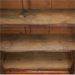 Victorian mahogany bookcase on cupboard of slender proportions, projecting cornice over dentil-frieze, fitted with twin-glazed doors enclosing three shelves, flanked by acanthus corbels, the base fitted with single frieze drawer over panelled cupboard, on skirted base