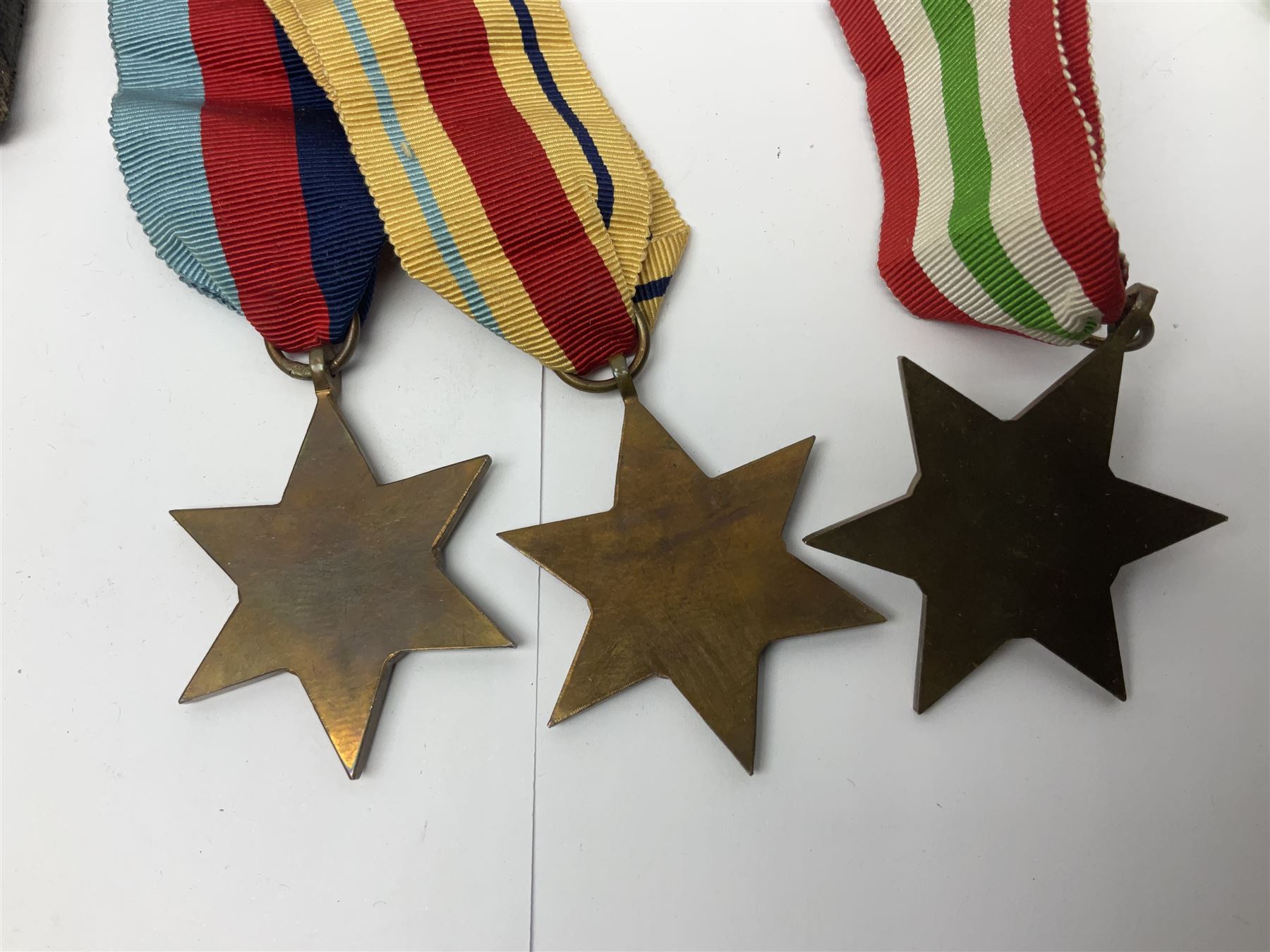 WWI pair of medals comprising British War Medal and Victory Medal awarded to 32682 Pte. W. Meadows W. Rid. R. in issue box; WWI pair of medals comprising 1914-15 Star and Victory Medal awarded to 3720 Pte. (later Cpl.) E. Petty W. York. R. with issue letter from Tank Corps; WWII group of five medals comprising 1939-45 War Medal, Defence Medal and 1939-45, Italy and Africa Stars; all with ribbons; and book of nineteen seaman's Certificates of Discharge to cook Charles Filburn 1893 - 1901 from various British ports