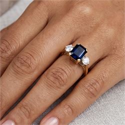18ct gold sapphire and diamond three stone ring, single octagonal cut sapphire of approx 0.90 carat, with a round brilliant cut diamond set either side, London 1996, total diamond weight approx 0.30 carat