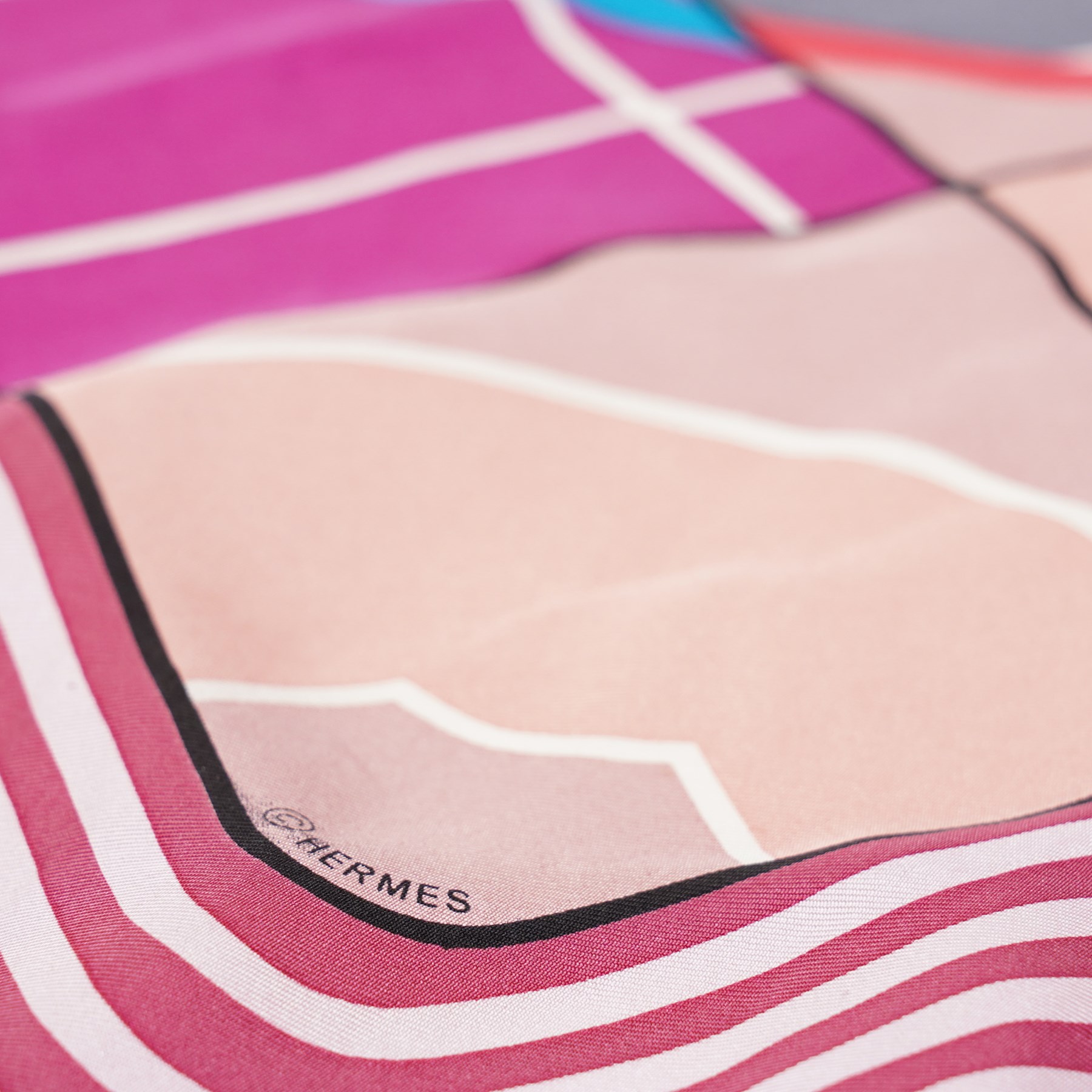 Hermès - ‘Hermès Sport’ silk scarf, designed by Anamorphée, first issued 2013, grey, burgundy, pink, blue and salmon colourway with hand-rolled edges