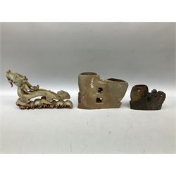 Three soapstone carvings, to include three toed dragon example, carved example with monkeys and another similar, together with carved wood figure, largest L29cm 