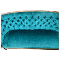 Victorian mahogany settee, upholstered in green buttoned fabric, moulded frame and scroll carved arm terminals, turned supports on castors