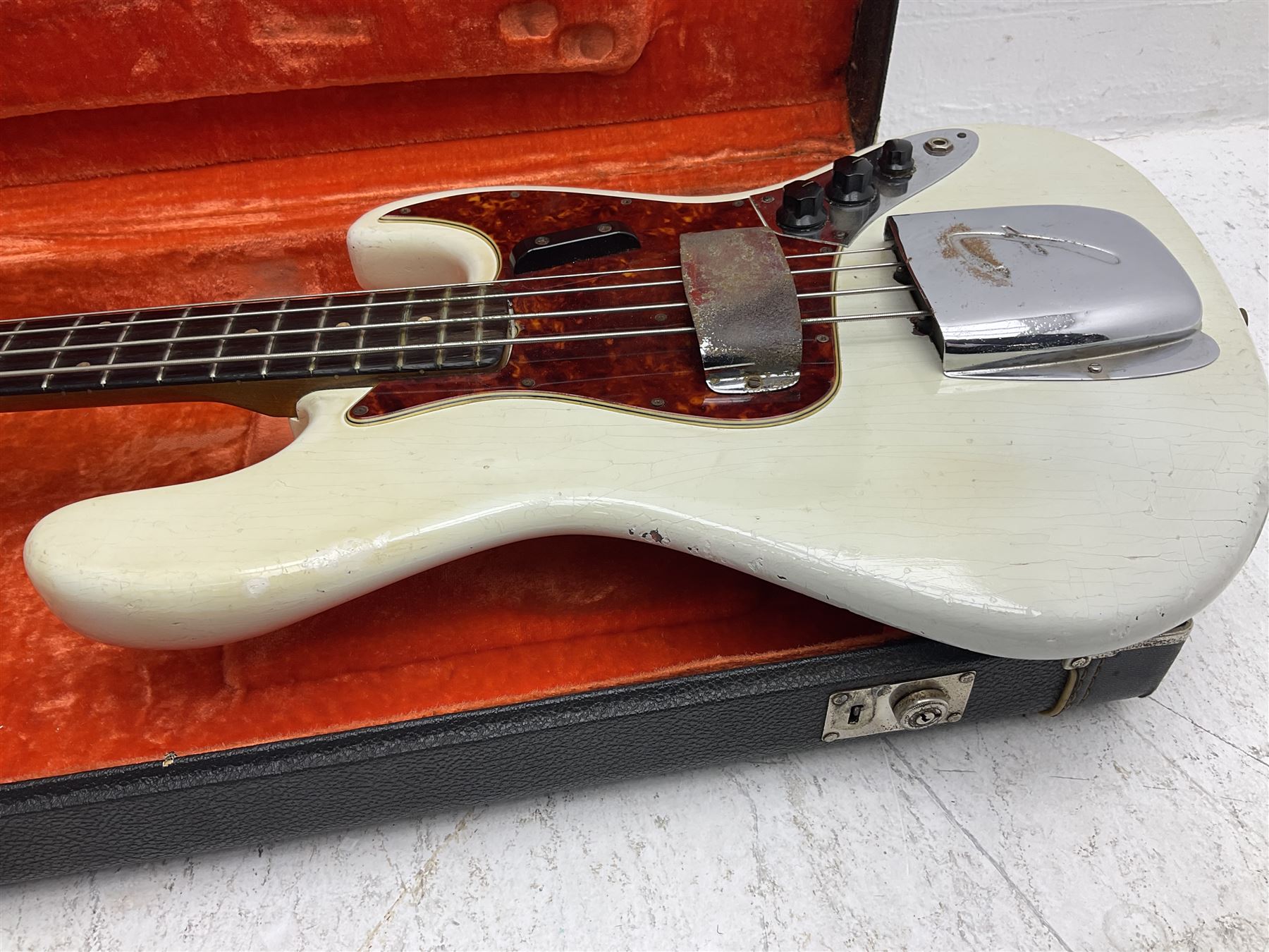 1963 Fender Jazz three-knob bass guitar; impressed with date code 7AUG63A on end of neck and serial no.L08587 on back plate; all original but re-finished in white in the 1970s; sold with photographs of the instrument in the 1960s with original finish and in the 1970s re-finished; L117.5cm; in original hard carrying case; Provenance: the professional guitar of Howard Livett from new to his death in 2005. Howard played in The Humperdincks, the backing group for Englebert Humperdinck, also played in the backing group for Max Bygraves and in the band Hedgehoppers Anonymous. The guitar is also sold with a manuscript letter of provenance from Howard's wife.