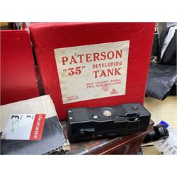 Camera lenses, flash guns and accessories, to include Tamron Adaptall 2,  tripods, a large metal trunk, together with photo developing equipment two enlargers, developer tanks and trays, Paterson contact printer etc.  