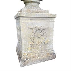 Pair of quality Neoclassical design Haddonstone cast stone garden urns, the globular  body decorated with relief foliate festoons and fruiting motifs, over a fluted socle, the rectangular pedestals with relief foliate wreaths and ribbon garlands