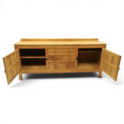 Mouseman - large adzed light oak sideboard, the rectangular top with raised galleried back, fitted with three central drawers flanked by panelled cupboards enclosing shelves, with wrought iron fittings, raised on octagonal feet, with signature carved mouse, by the workshop of Robert Thompson, Kilburn