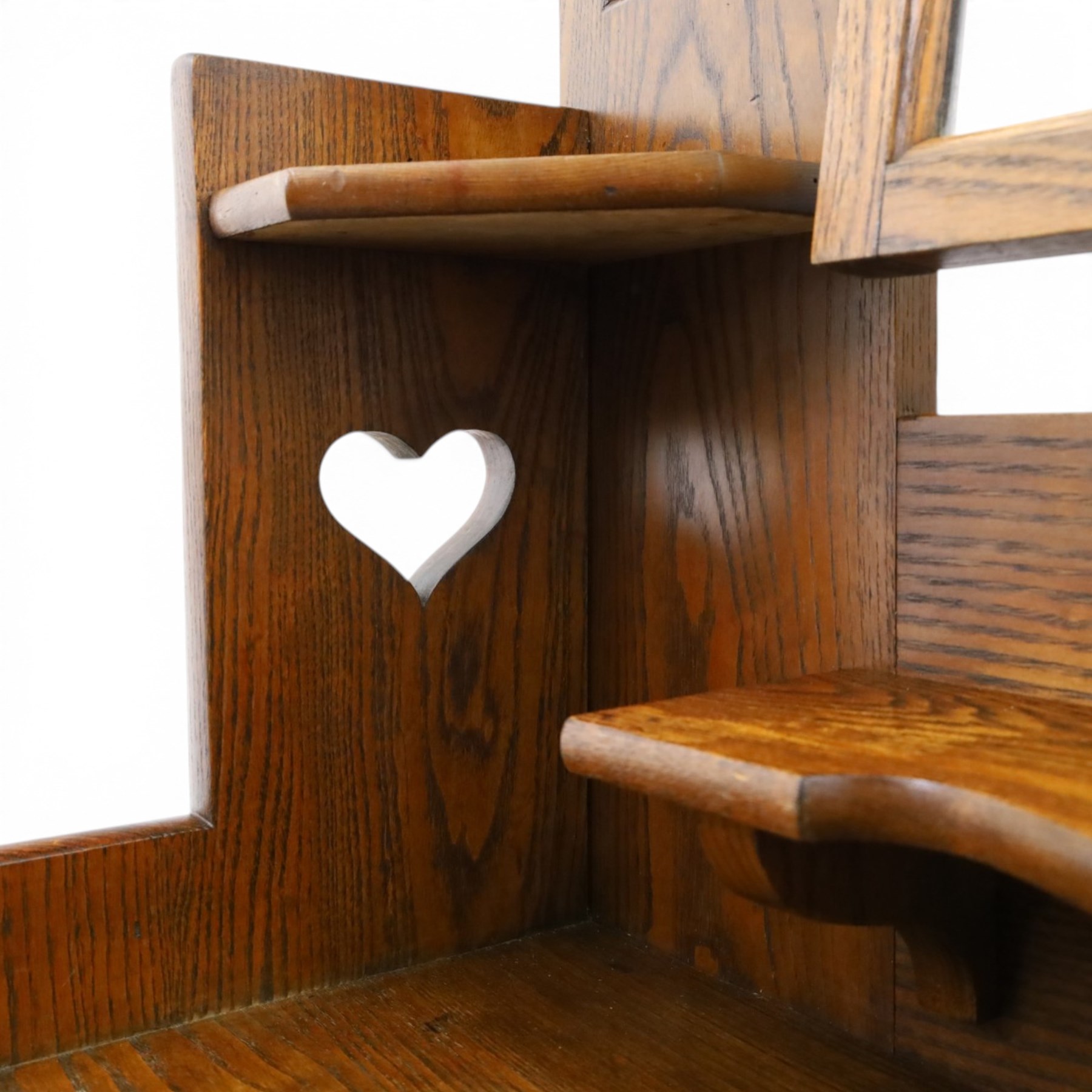 Shapland & Petter - oak mirrored dressing chest, tilted mirror flanked by tulip carved supports, shaped shelves with heart cut outs, above two short over one long drawers, with brass handles and stamped S & P on the locks, raised on shaped supports