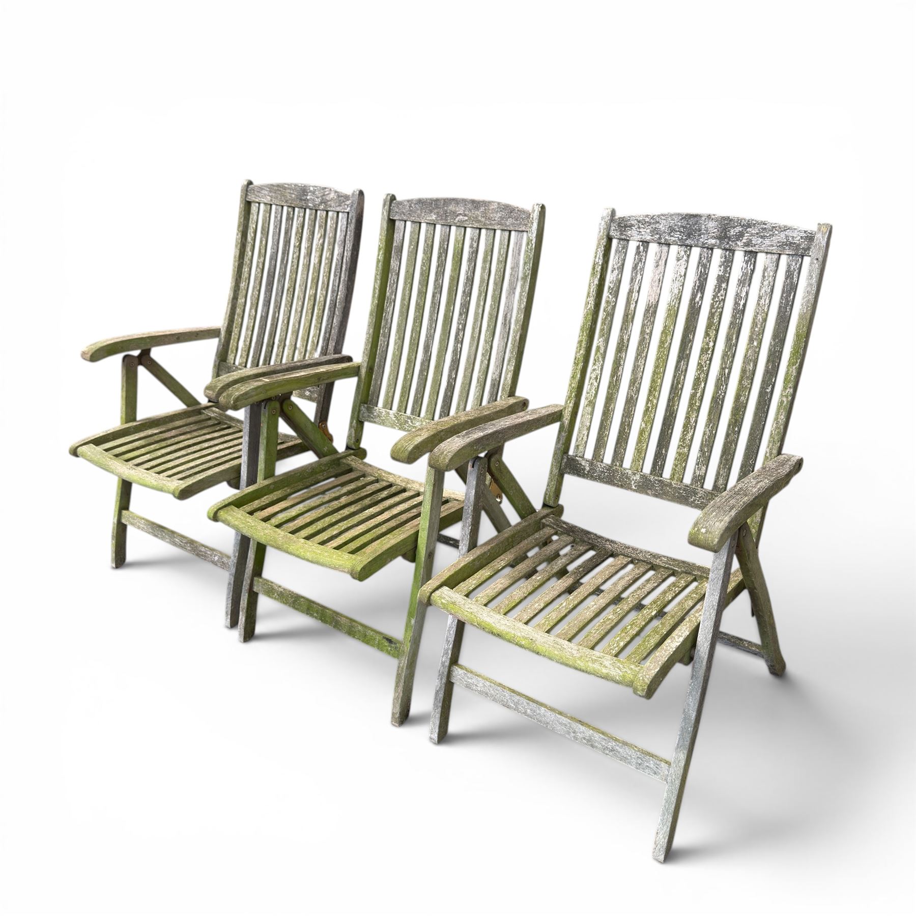 Five piece teak garden dining set, comprising circular folding table and four folding armchairs, with slatted seats and backs in a weathered finish