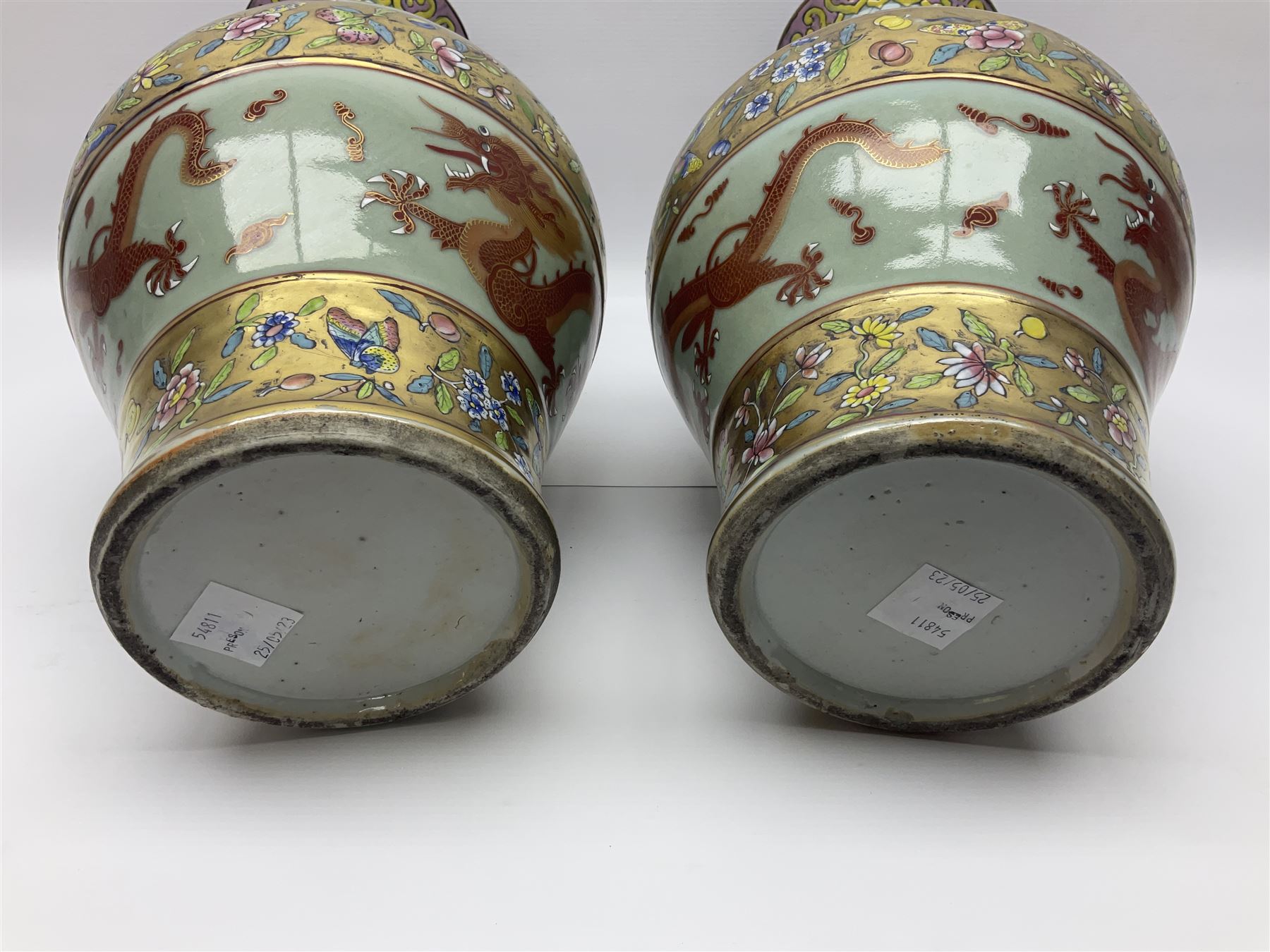 Pair of early 20th century Chinese vases decorated with dragons chasing a flaming pearl, with a gilt border of butterflies and floral sprigs, with Elephant head handles, H44cm 