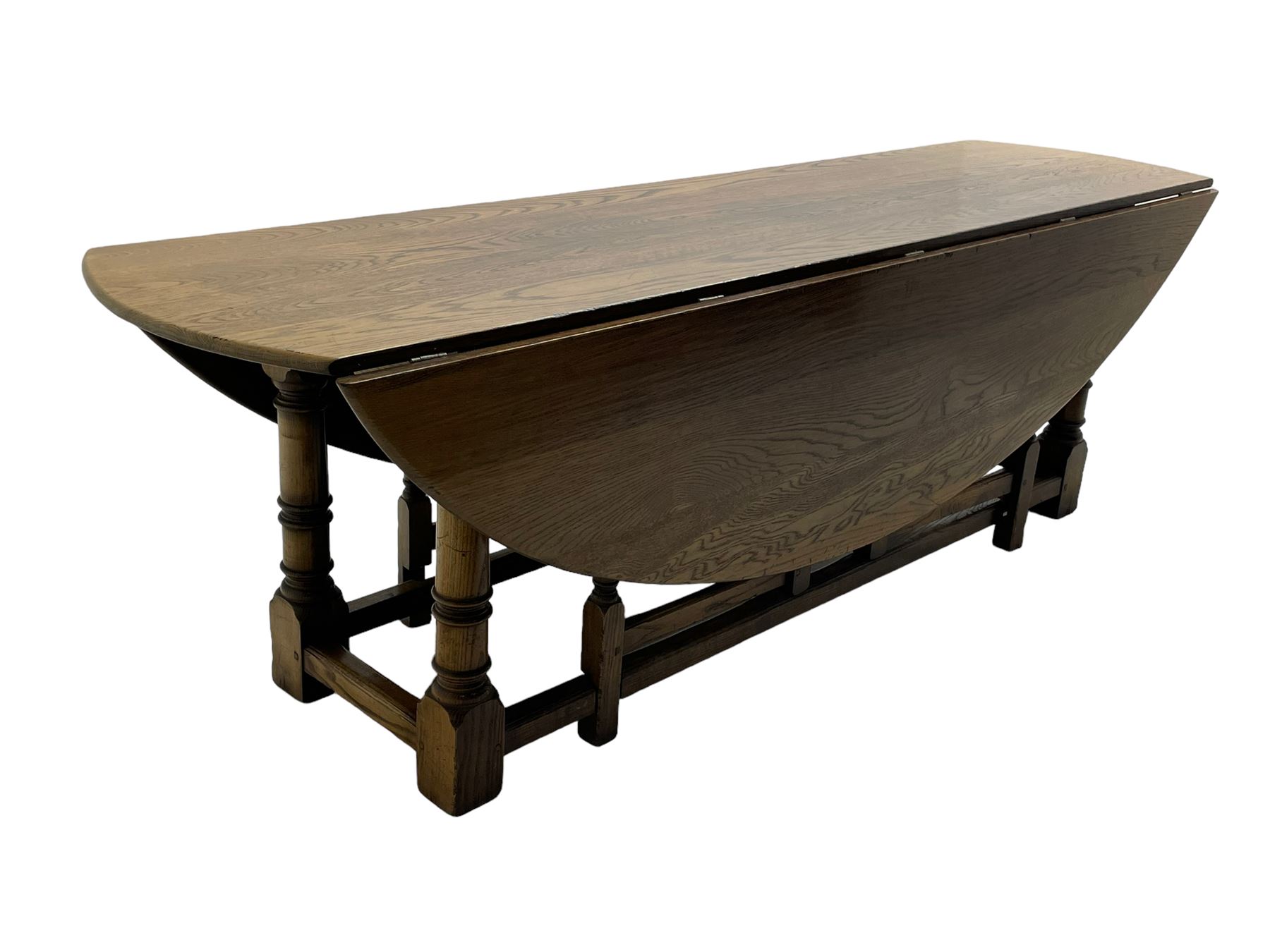 Large 18th century design oak wake or dining table, oval drop-leaf top, turned supports with double gate-leg action base, united by moulded stretchers 