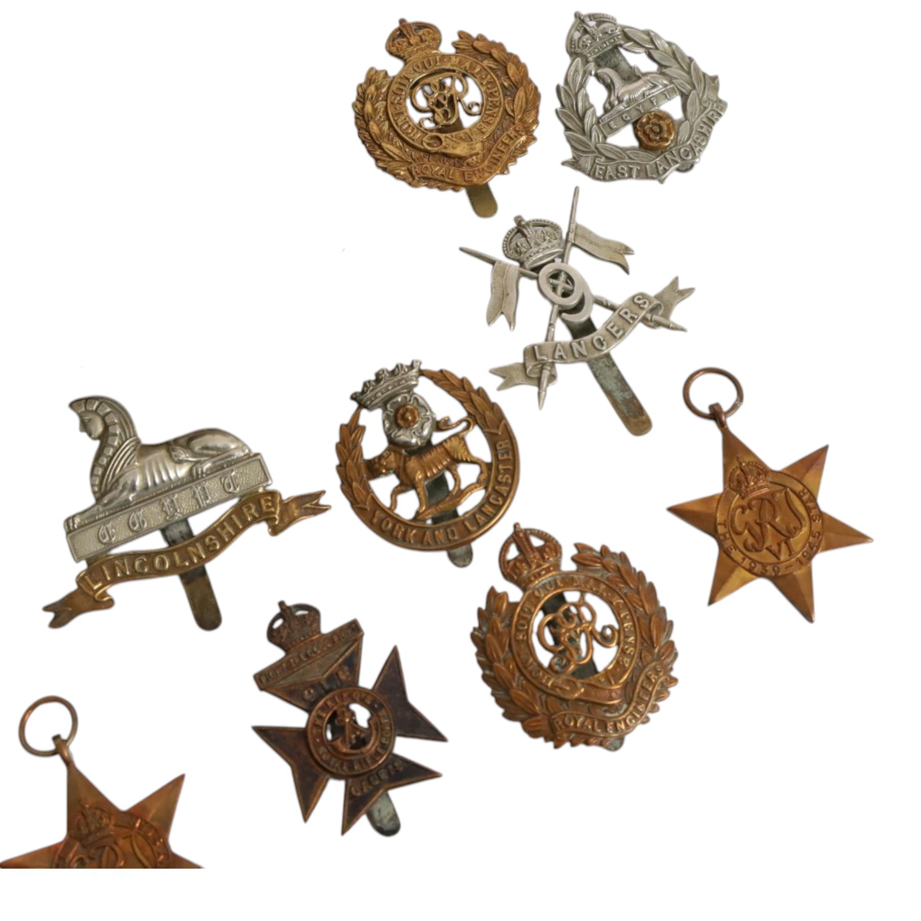 WWII seven British medals, comprising two War medals, two 1939-45 stars, African star, Italy star and French and German star, together with a collection of cap badges including The Kings Royal Rifles, Royal Engineers, East Lancashire, York and Lancaster regiment museum etc  