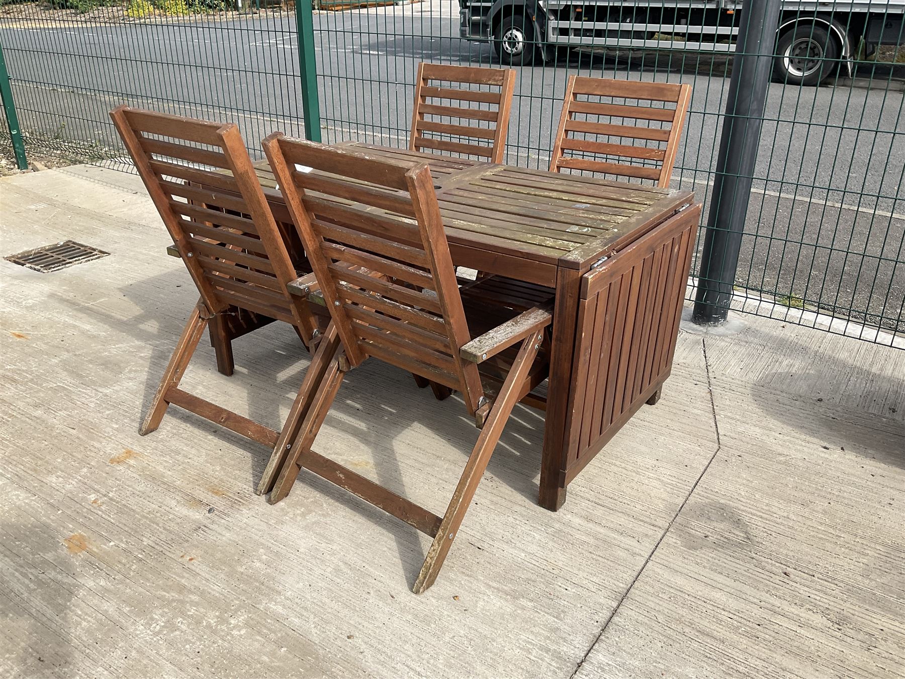 Rectangular teak drop leaf garden table, and four slatted armchairs