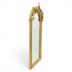 Pair of Louis XV style giltwood overmantel mirrors, the arched rectangular frame surmounted by an elaborate pierced cresting of acanthus scrolls, rocailles and floral swags, the moulded frame with continuous foliate carving and beaded inner slip