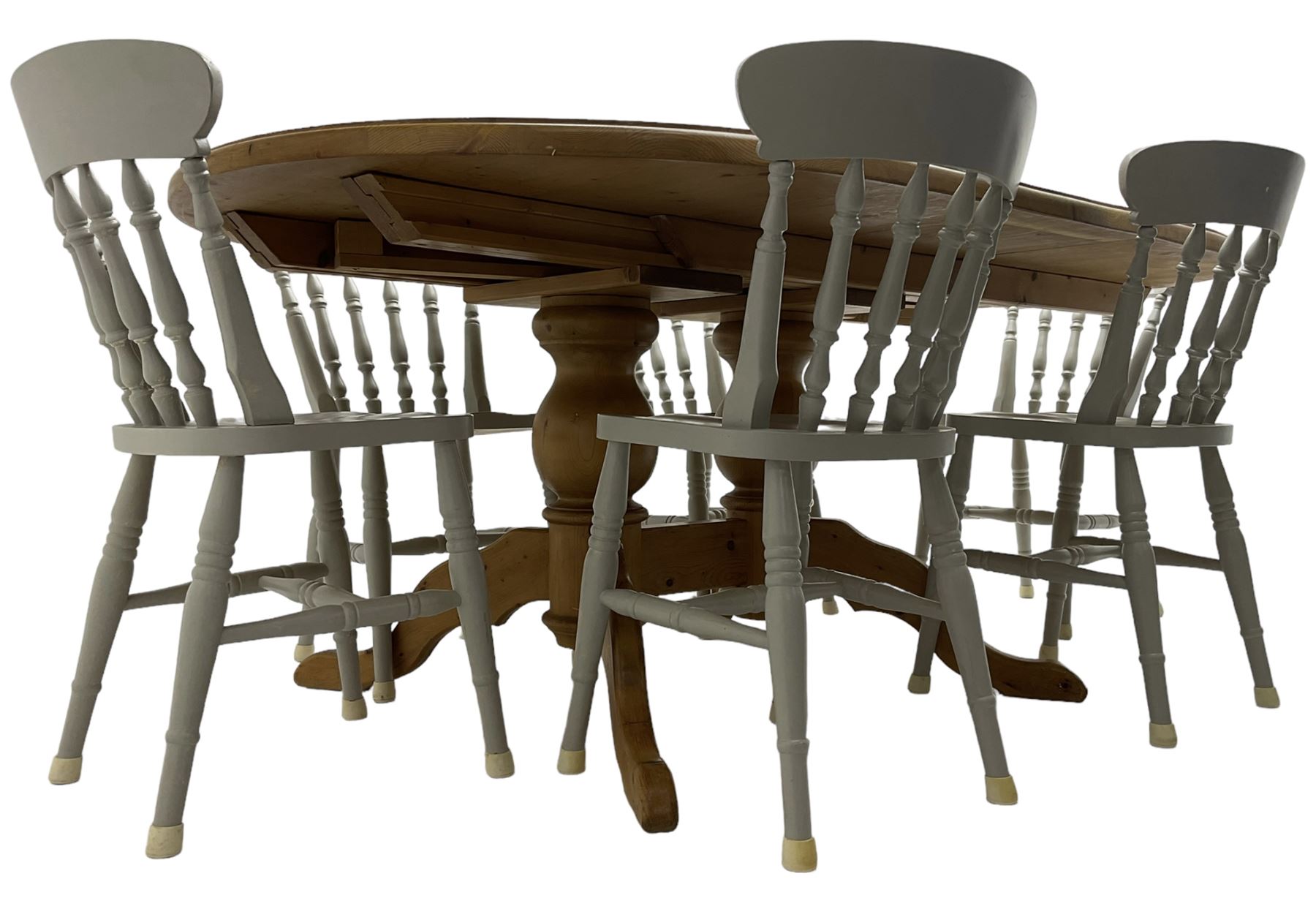 20th century pine extending dining table, oval top over twin bulbous turned pedestal base united by stretcher, with additional leaf (W160cm D120cm H79cm); and set of seven ash painted dining chairs, spindle back, raised on ring turned supports joined by H-stretcher