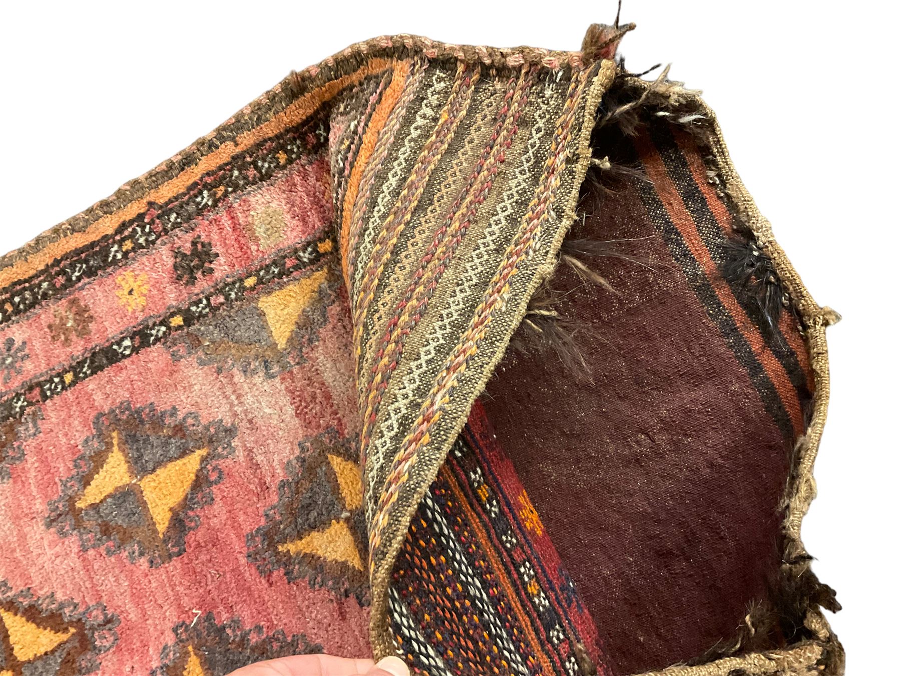 Antique Persian red ground saddle bag, decorated with all-over Boteh motifs, geometric patterned border (127cm x 68cm); Persian indigo ground saddle bag, decorated with two geometric ivory lozenges (113cm x 62cm); Persian red ground saddle bag decorated with lozenges and multi-band border (110cm x 65cm) 