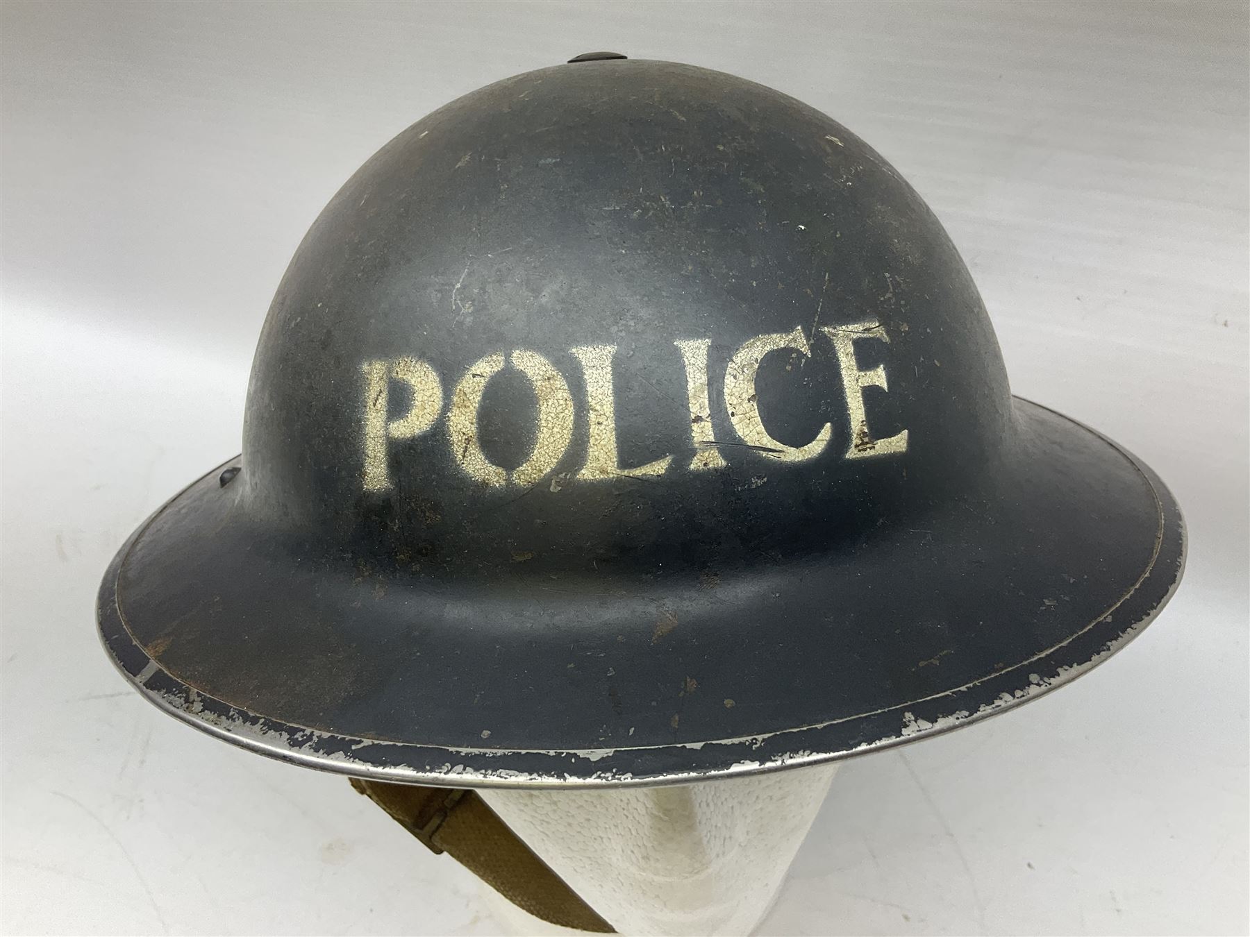 WW2 Home Front 'Police' black painted steel helmet with original liner and webbing chin strap, impressed R.O. Co. 1/1939; and re-painted shell only for WW2 Wardens steel helmet impressed AMC II 1941 C676 (2)