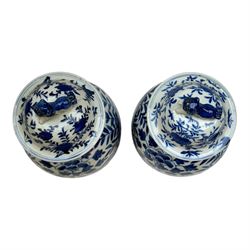 Pair of Chinese vases and covers, of baluster form the blue and white design depicting dragons in foliage, with character marks beneath, H38cm