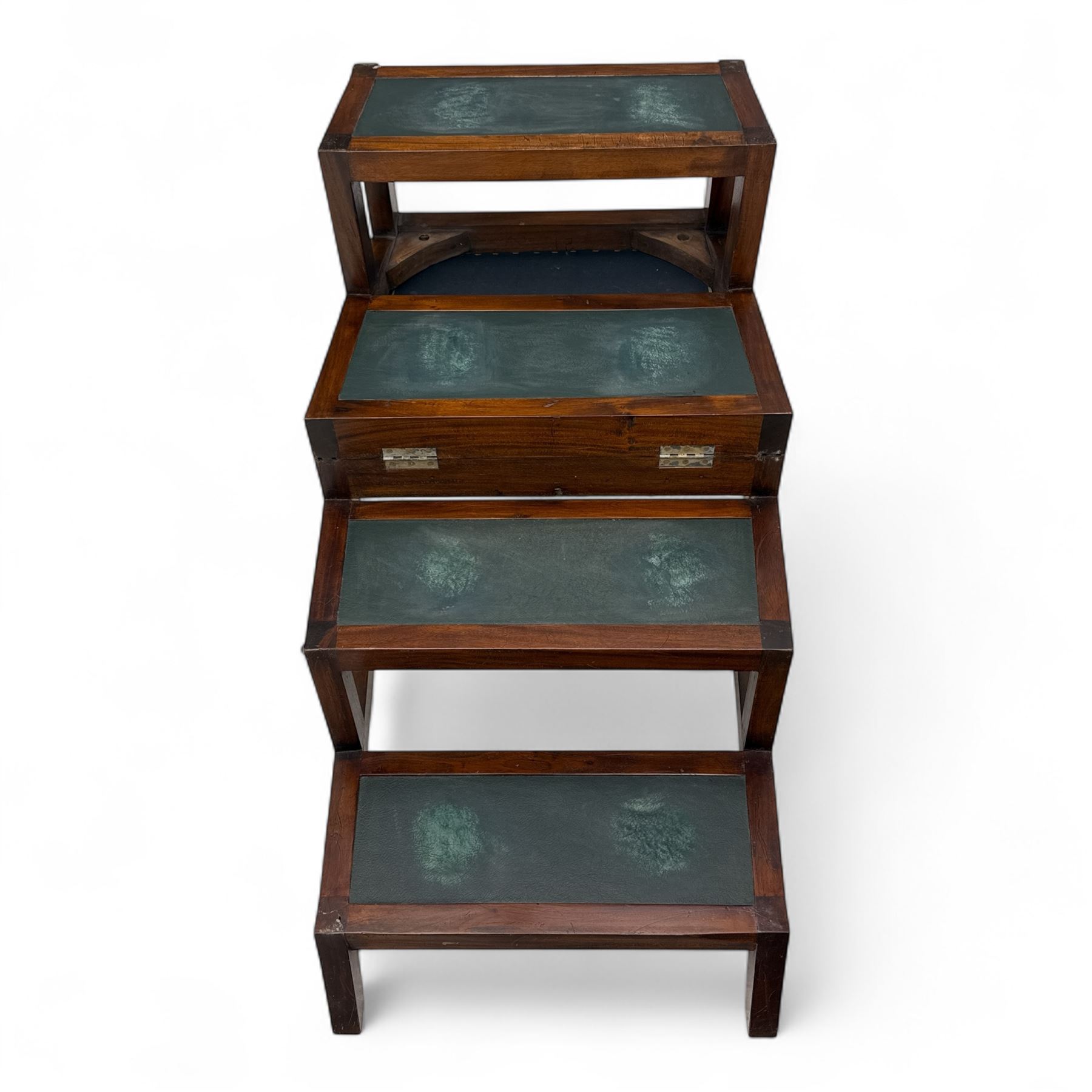 In the manner of Morgan & Sanders - early 20th century Regency design mahogany metaphoric library chair and steps, rectangular panelled top-rail with applied roundels with scrolling arms and upholstered seat and cushion, hinged and folding design transforming into four carpeted steps

Reference: The present lot is based on a design for a metamorphic library chair published by Morgan & Saunders circa 1810, P.Agius, Ackermann's Regency Furniture & Interiors, plate 29, page 60