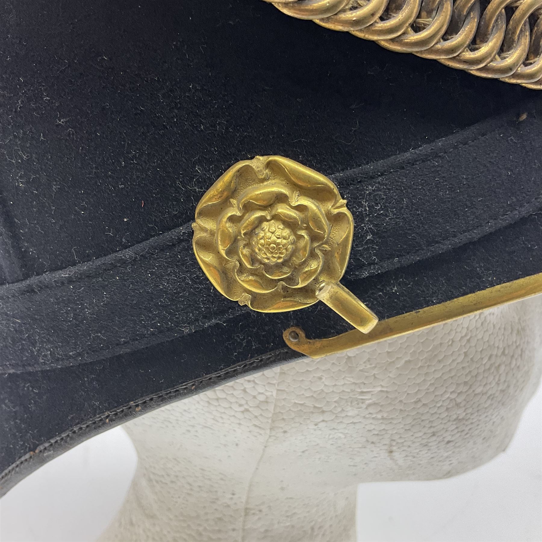 Late Victorian North Staffordshire Regiment Officer's Home Service Blue Cloth Helmet, having incorrect other ranks gilt metal Queen's crown helmet plate to the front with later leather backing, removable spike to the top on a shaped cruciform base with rosette fittings, rosette side bosses, brass trim to the front peak, and leather and velvet backed chin scales, with leather sweat band, the interior with makers stamp for Hawkes & Co 14 Piccadilly London