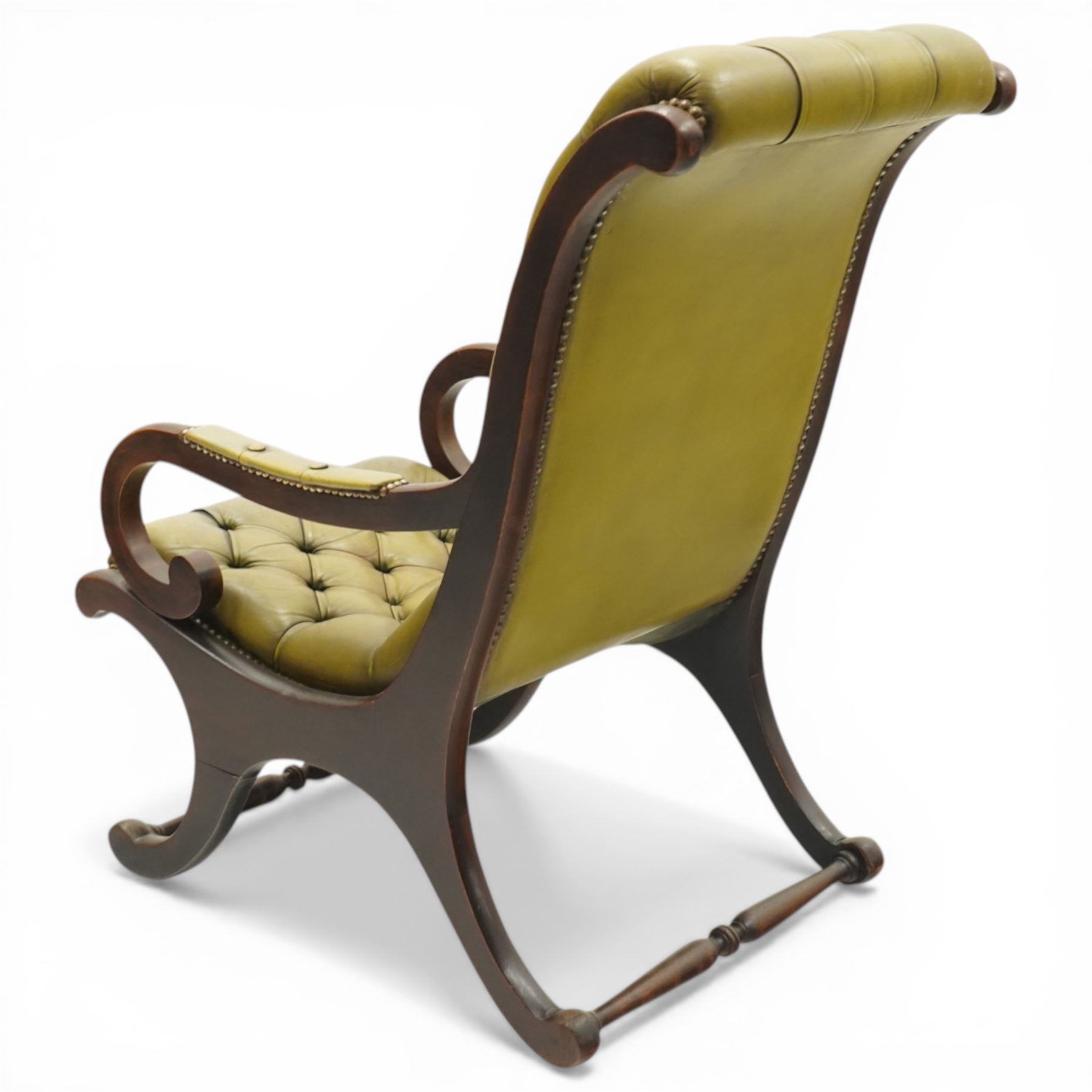 Regency design slipper chair upholstered in buttoned green leather, down swept arms with padded sections, swept back and shaped frames