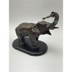 A spelter mystery clock modelled as an elephant supporting the clock upon its trunk, the white circular dial with black Arabic numerals, H26.5cm. 