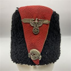 WW2 German small size Balkan style hat with 'SS' metal badges; red cloth top and flash to front with black persianelle type sides; lined in brown card with leather sweatband