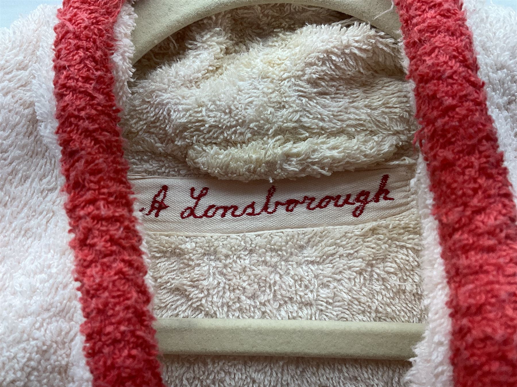 On the direct instructions of Anita Porter nee Lonsbrough Great British Olympic and Commonwealth Games gold medal winning swimmer - collection of early and international memorabilia comprising original Huddersfield Bath Club track suit top bearing eight stitched on cloth badges including British Empire & Commonwealth Games 1958 England Team, YSASA, North Eastern Counties ASA, ESSA Division 3,  English Schools Swimming Association winner etc
The swimming costume Anita wore at the 1958 Commonwealth Games in Cardiff, her first major championships, where she won two gold medals. The grey elastic on the sides, in those days, she would use to make it tighter and more streamlined.
Blue track suit from the 1960 Olympics which she wore on the podium receiving the gold medal.
1960 pool side towelling robe used at the Rome Olympics (interesting to note her name is spelt wrong on the embroidered label).
1962 Commonwealth Games pool side towelling robe used in Perth Australia when winning three Gold medals. 
It was also this year she became BBC Sports Personality of the year, the first female to do so.
Her 'lucky' pool side towel which she took with her to every event she competed in and which can be seen round her neck in many official celebratory photographs. Copies of some of these photographs are included for identification.
In addition there are two souvenir programmes of an evening event to honour Anita at The Theatre Royal Huddersfield and she has kindly signed the front cover on one of these.