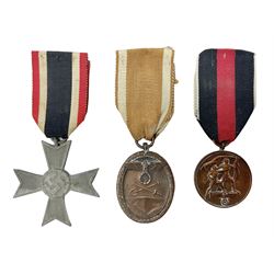 Three WW2 German medals - Defences Medal, Czech Occupation Commemorative Medal and War Merit Cross; all with ribbons (3)