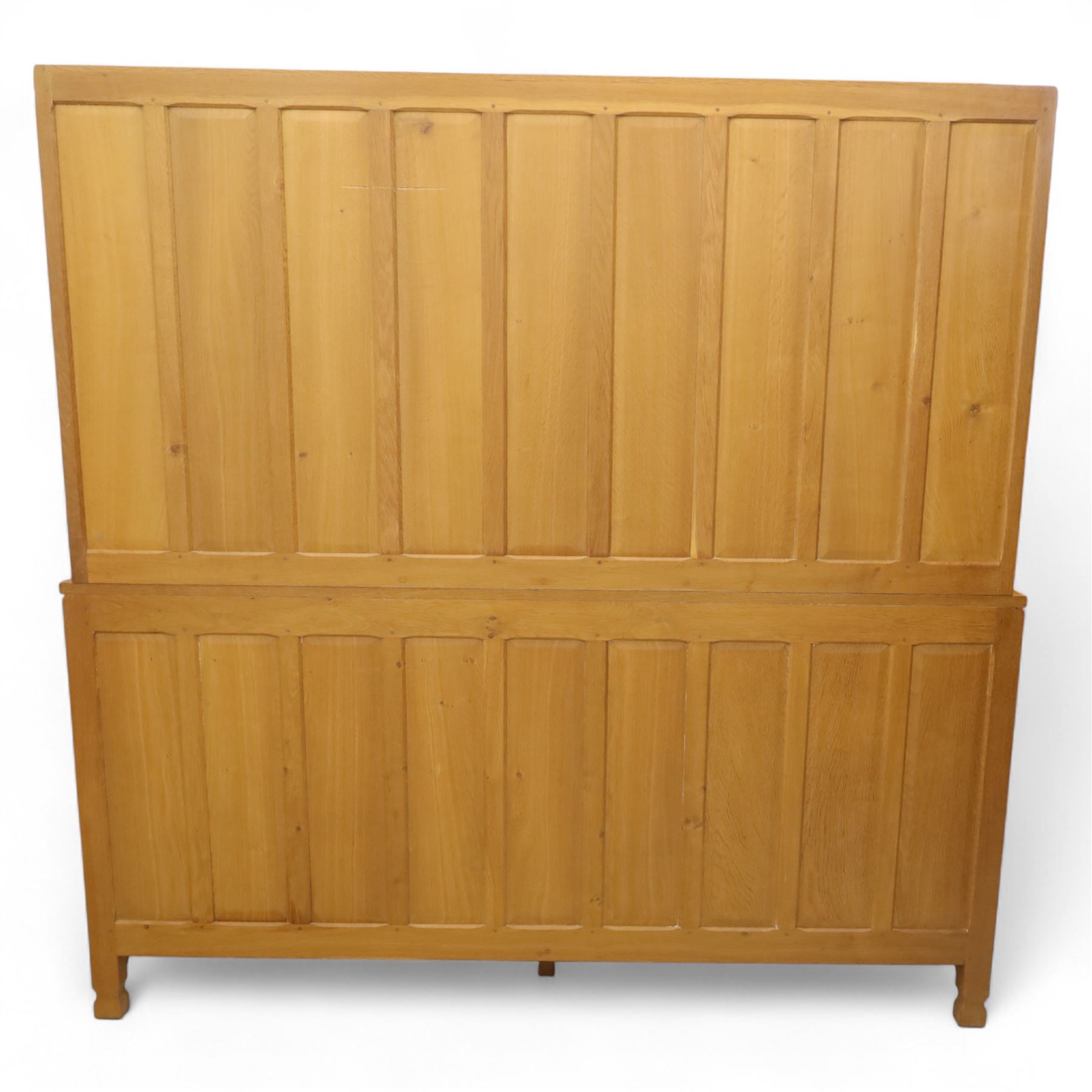 David 'Oakleafman' Langstaff - oak three drawer dresser, the scalloped cornice above a back with central open shelves flanked by two glazed and leaded cupboard doors opening to glass shelves, upon a base with adzed top carved with signature leaf, three drawers and three panelled cupboard doors with turned handles, upon octagonal feet, from the workshop of David Langstaff, Easingwold, Yorkshire