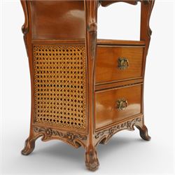 And So To Bed - pair of cherry wood and cane 'Libertine' bedside tables, glass top above a shaped and carved apron, with open recess above two drawers with brass handle, flanked by caned sides, raised on short cabriole supports 