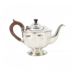 1930s silver three piece tea service, comprising teapot, open sucrier and milk jug, each of circular part fluted form, the jug and teapot with Bakelite type handles, hallmarked Viner's Ltd,  Sheffield 1935