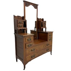 Late 19th century walnut dressing chest, drop centre with raised swing bevelled mirror and small trinket drawers, fitted with four small drawers and two long drawers