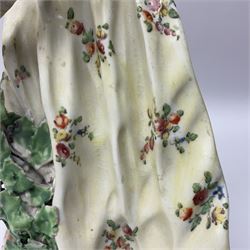 18th century Derby figure of Diana the huntress, circa 1760, modelled reaching for an arrow from quiver across her back, with recumbent hound at her feet, upon a scrolled base with bocage detail, H27.5cm