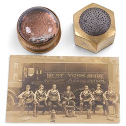 Two 1930s mining interest brass paperweights, comprising a hexagonal brass and steel examp...