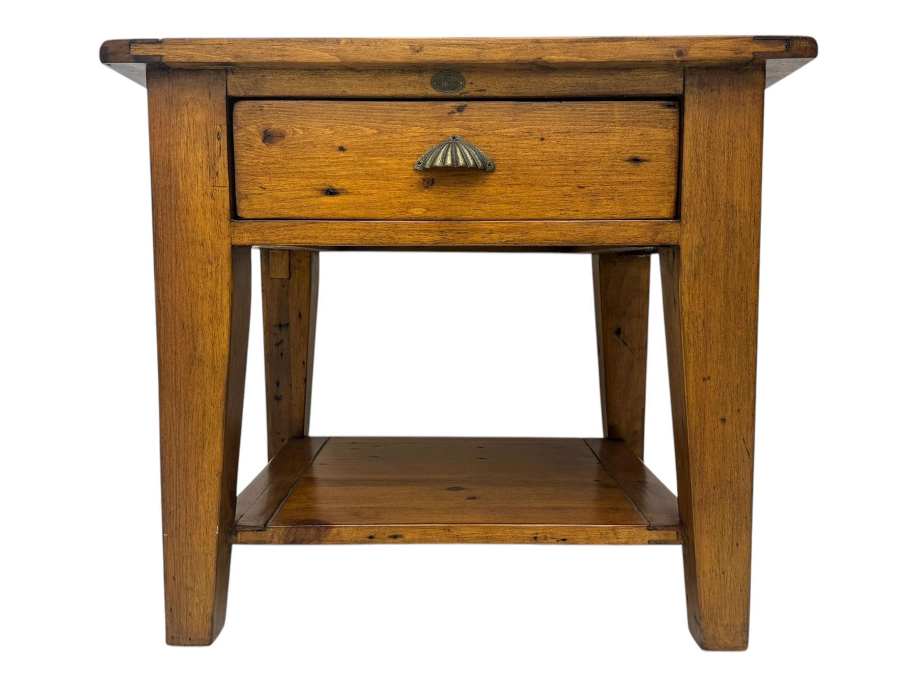 Contemporary hardwood lamp table, the rectangular boarded top over a single drawer with shell cup handle, standing on tapering supports united by undertier 