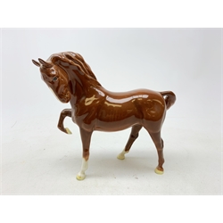  A Beswick figurine, modelled as a chestnut horse with front leg raised, with printed mark beneath, H19cm.   