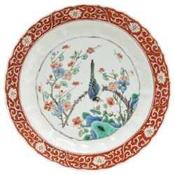 Chinese Kangxi famille verte plate, decorated with a bird perched upon a blossoming branch, within an iron red foliate border, D22cm