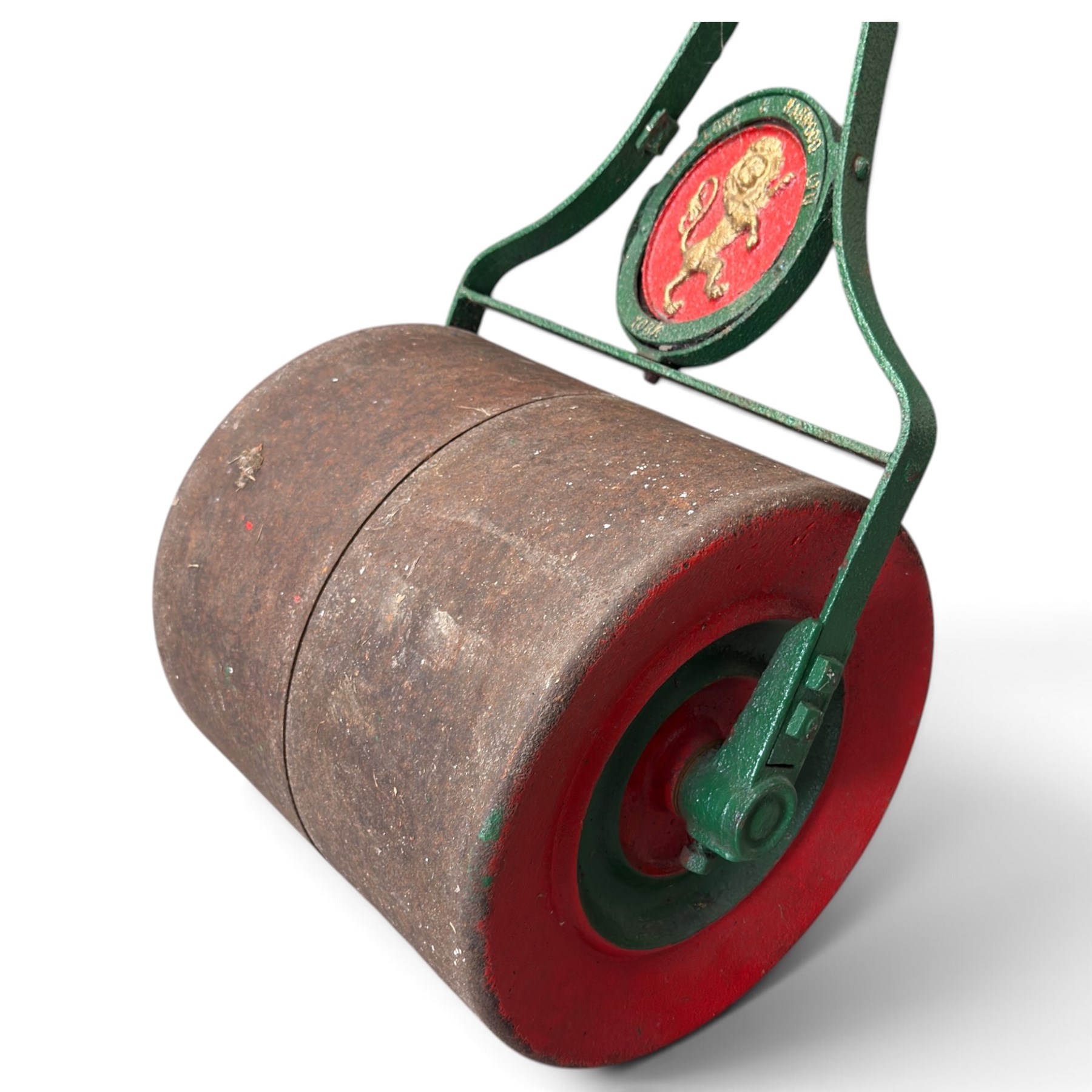 Woollons & Harwood Ltd., York - Edwardian green and red-painted cast iron garden roller, handle and stem over circular rampant Lion plaque stamped with maker