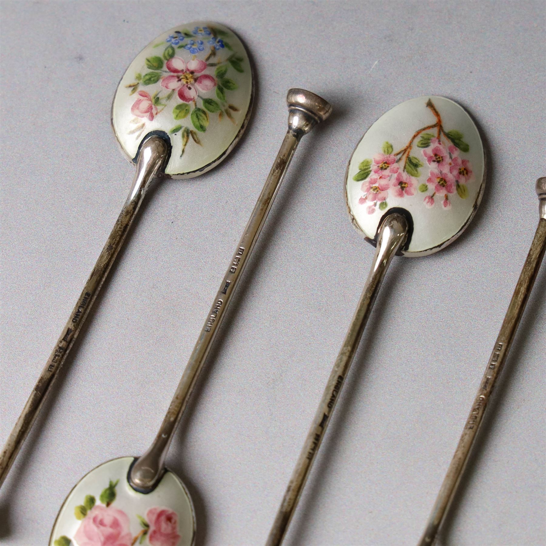 Set of six enamel coffee spoons, each decorated with guilloche enamel flowers to the underside of the bowls,  hallmarked Walker & Hall, Birmingham 1951, in fitted case