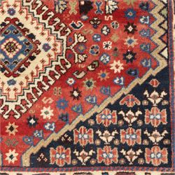 Persian Shiraz rug, wool on cotton foundation, with central row of linked diamond medallions in ivory, indigo and madder tones, stylised rosettes and angular vine motifs throughout, framed by a geometric border