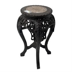Late 19th century Chinese hardwood pedestal stand, circular top with inset marble panel, carved apron with openwork foliate and floral motifs, raised on cabriole supports with stylised claw and ball feet united by square undertier