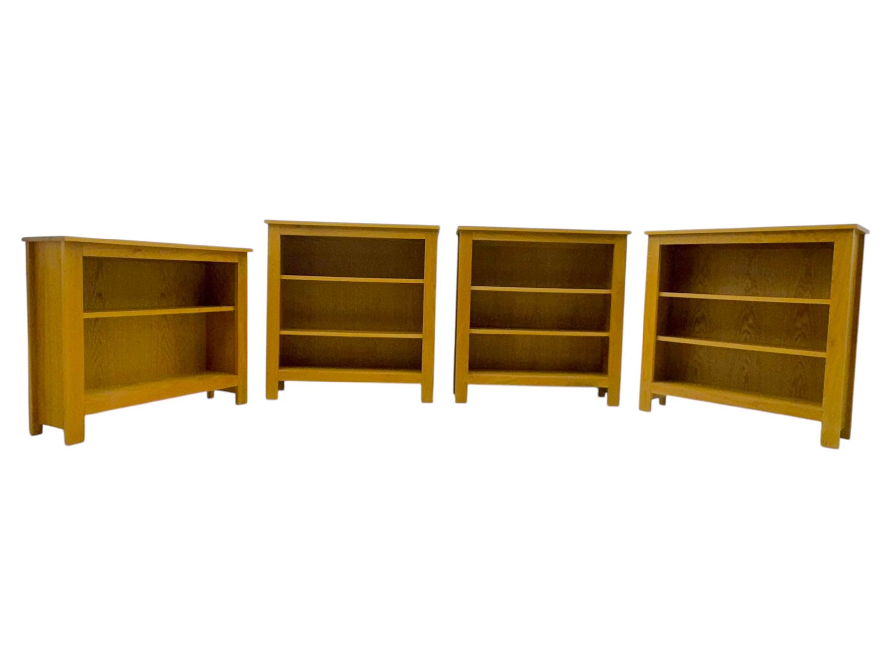 Five light wood open bookcases, four with two adjustable shelves, (W89cm, D29cm, H94cm), one with one adjustable shelf (W89cm, D29cm, H77cm)  