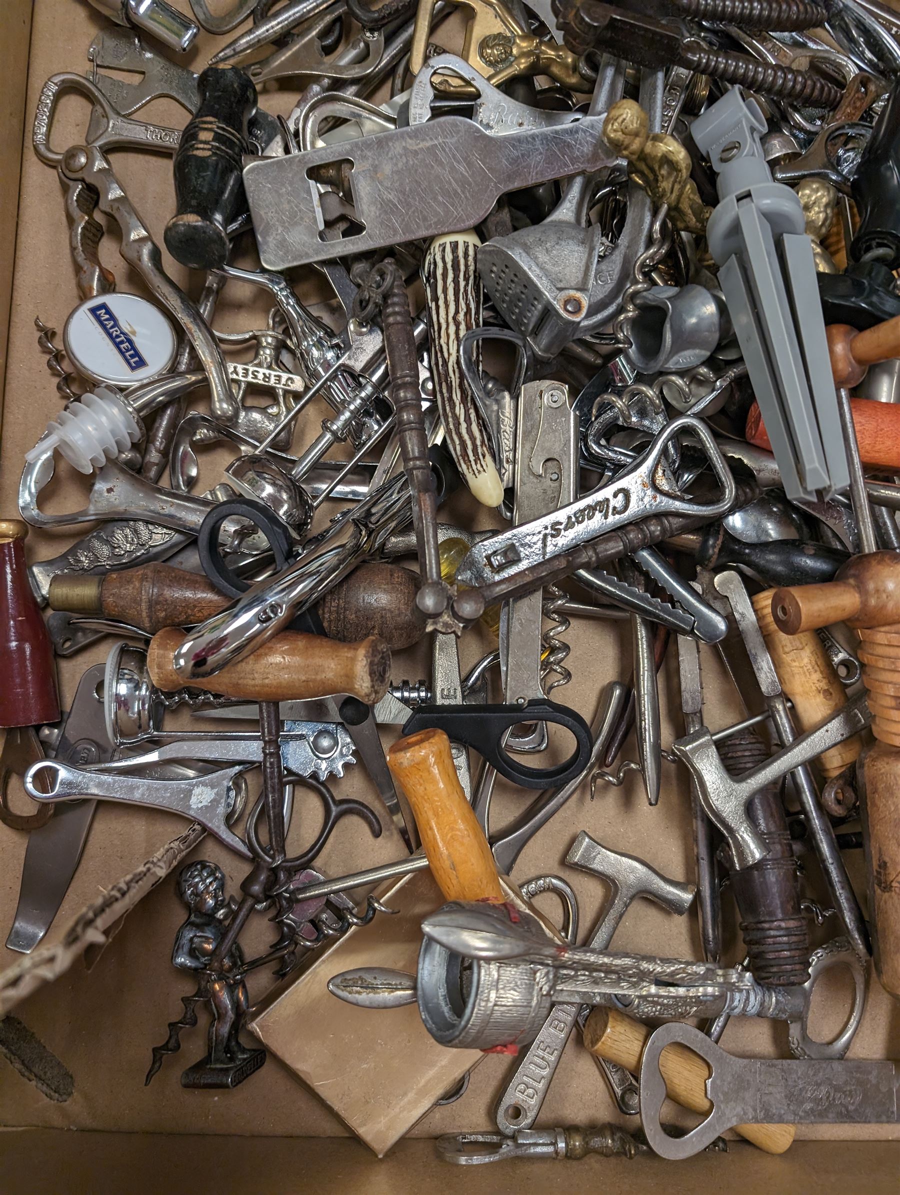 Collection of cork screws, bottle openers and bottle pourers, including turned wooden examples