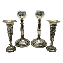 Pair of silver candlesticks, each upon knopped stem and weighted base, hallmarked, together with a pair of white metal vases, repousse decorated with wild animals, upon weighted bases, tallest H13cm
