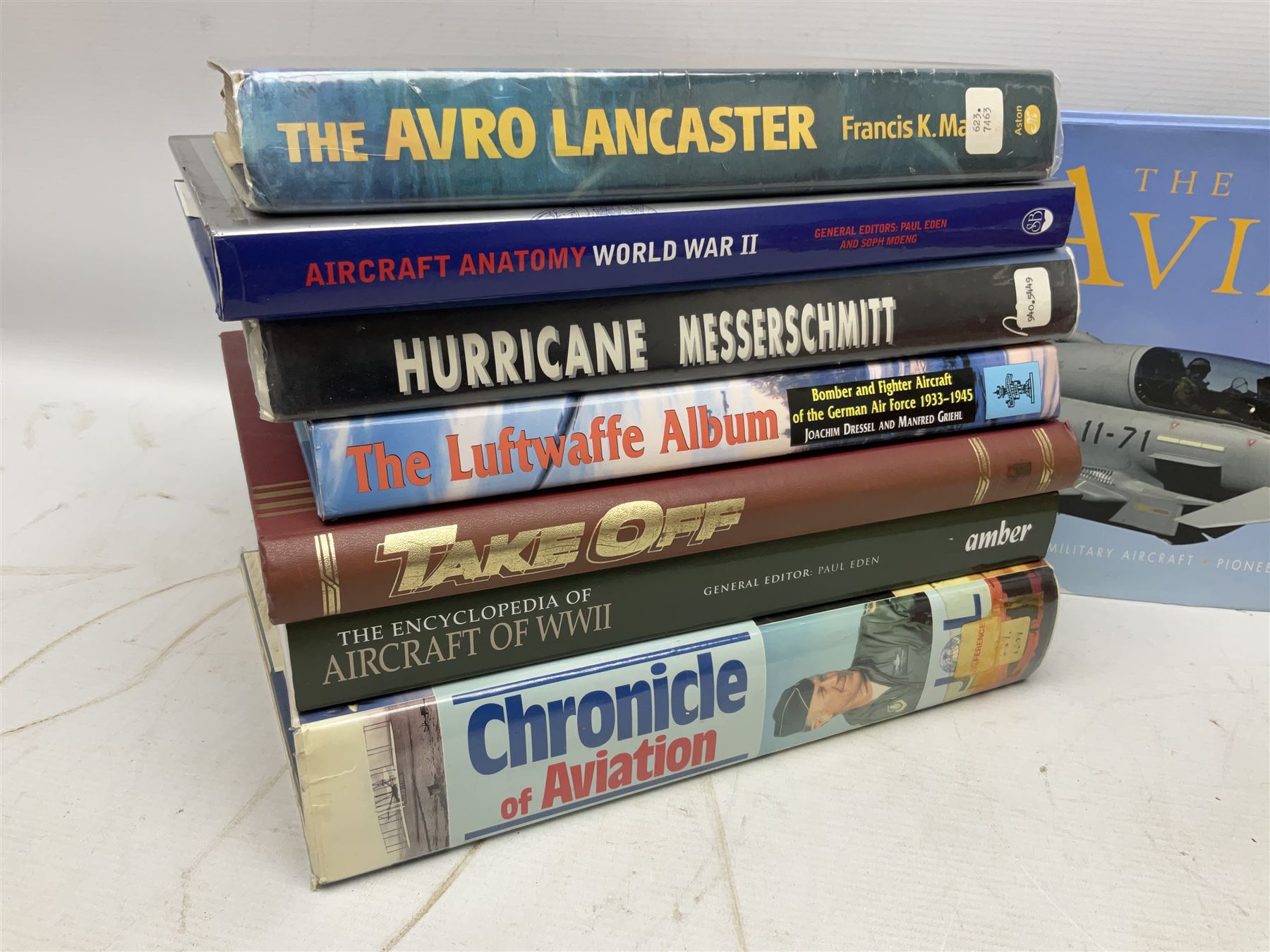 Ten books of predominantly military aircraft interest including Aircraft Anatomy World War Two, Hurricane Messerschmitt, The Avro Lancaster, The Luftwaffe Album, Encyclopaedia of Aircraft of WWII etc; together with a scrap album of WW2 newspaper cuttings