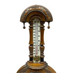 An Edwardian hall barometer with a compensated Aneroid movement by the German maker Julius Gischard, porcelain four-and-a-half-inch register measuring barometric air pressure from twenty-six to thirty-one point nine inches, weather predictions written in upper and lower case gothic script with initial letters highlighted in red, blue steel indicating hand and brass recording hand, dial bezel with flat bevelled glass, spirit thermometer recording temperature in degrees Fahrenheit and Celsius on an unglazed opal plate with arched crest above, Dial inscribed “Wooley & Sons Manchester”.
H46cm    


