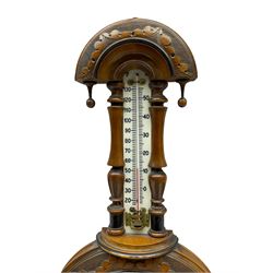 An Edwardian hall barometer with a compensated Aneroid movement by the German maker Julius Gischard, porcelain four-and-a-half-inch register measuring barometric air pressure from twenty-six to thirty-one point nine inches, weather predictions written in upper and lower case gothic script with initial letters highlighted in red, blue steel indicating hand and brass recording hand, dial bezel with flat bevelled glass, spirit thermometer recording temperature in degrees Fahrenheit and Celsius on an unglazed opal plate with arched crest above, Dial inscribed “Wooley & Sons Manchester”.
H46cm    



