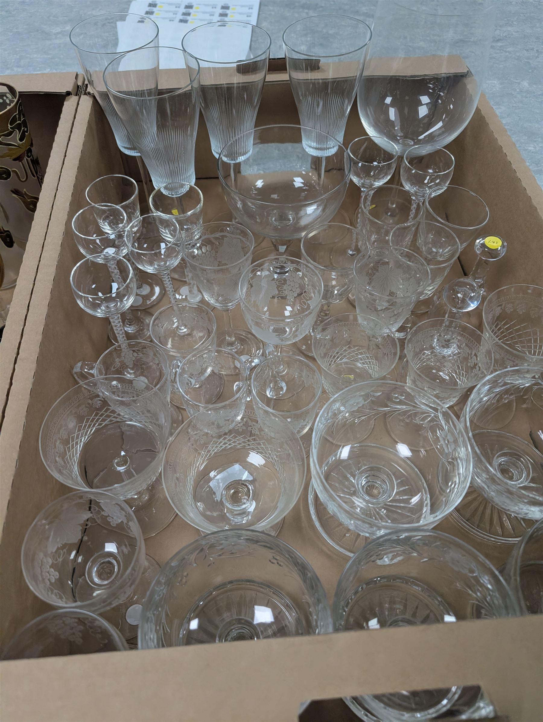 Collection of assorted glassware, to include Czech hand painted lemonade set, with tall jug and six glasses, pair of Art Nouveau blue glass vases painted in gilt with foliate tendrils, John Walsh style bowl with cut leaves decoration, various Edwardian drinking glasses with cut and etched decoration, etc., in two boxes