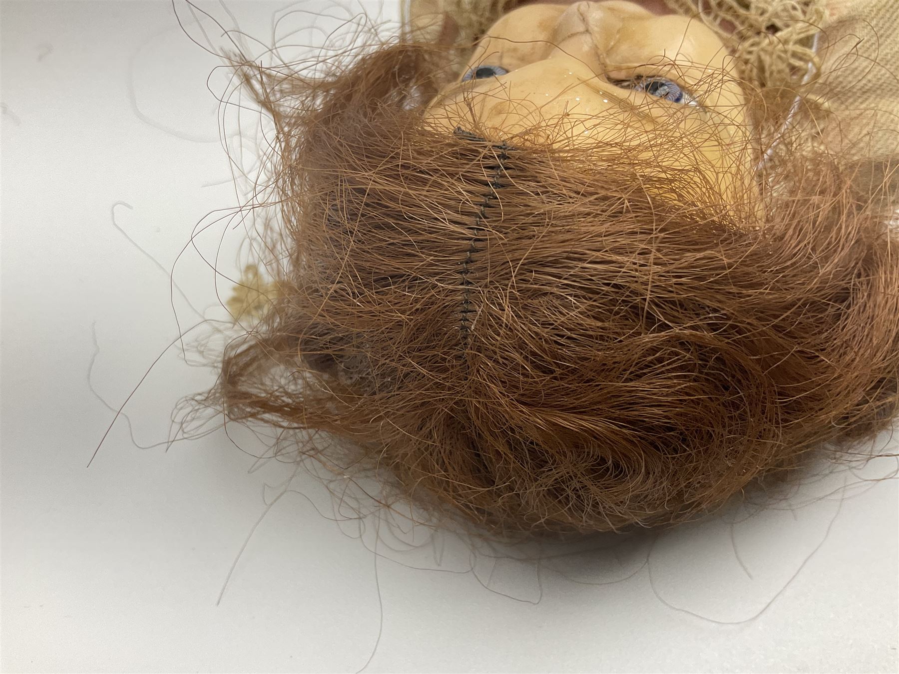 Victorian wax shoulder head doll with applied hair, inset glass eyes and jointed body with composition lower limbs; faded pink dress H35cm